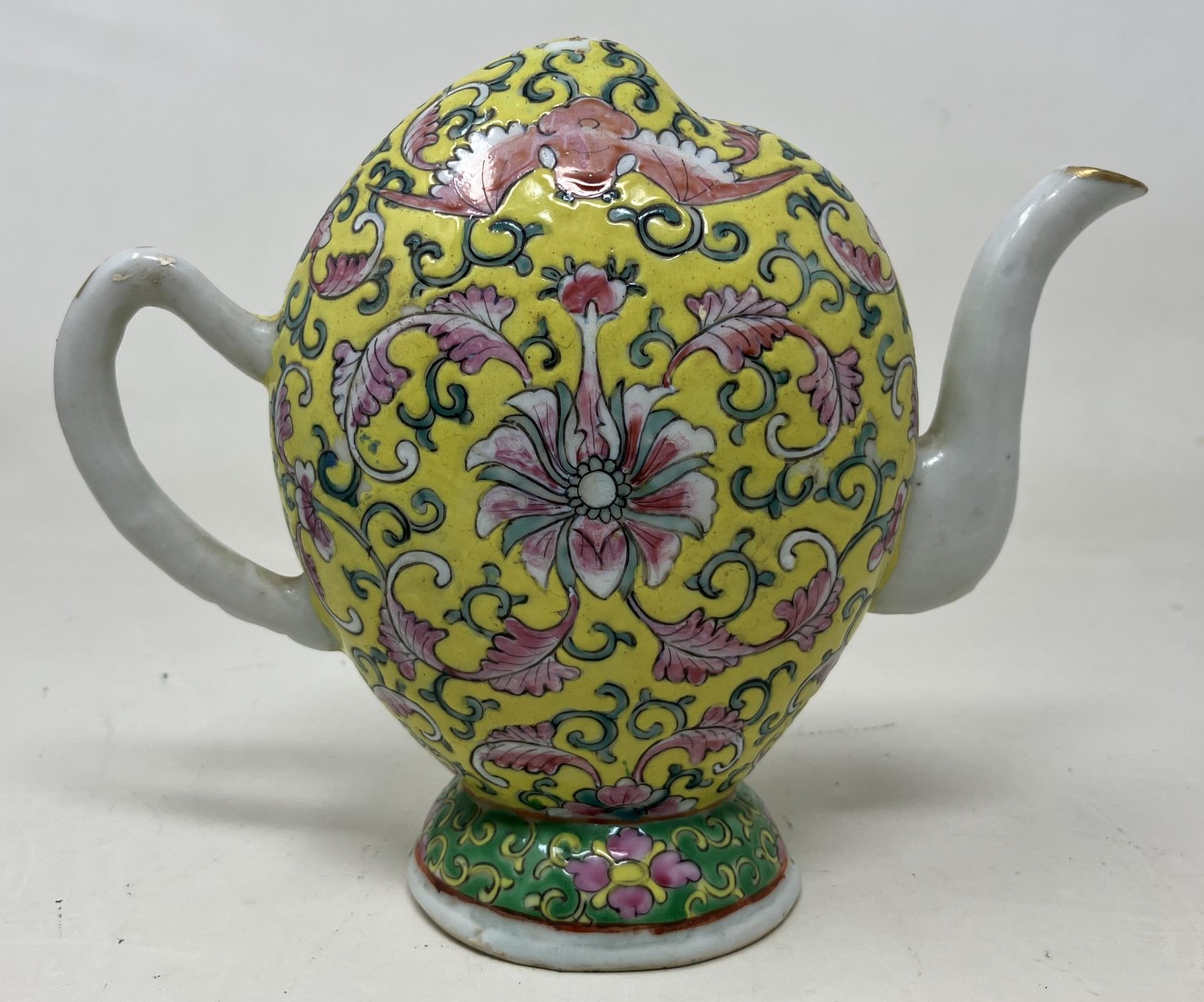 A Chinese Cadogan style teapot, of melon form, decorated bats and floral motifs on a yellow