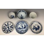 A Chinese porcelain tea bowl and saucer, decorated figures, the saucer 10 cm diameter, two other tea