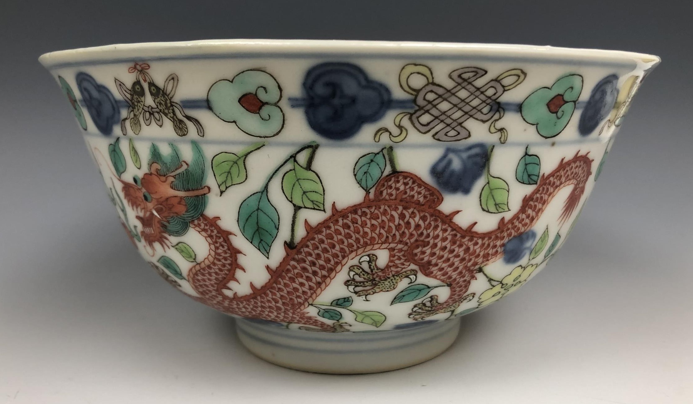 A Chinese porcelain bowl, the interior decorated a dragon, the exterior dragons, phoenix and other