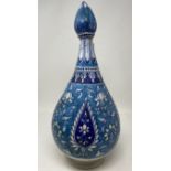 An Isnik blue ground vase and cover, 37 cm high with large losses and restored