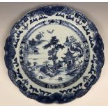 A set of four Chinese plates, decorated landscapes in underglaze blue Plate 1 - A couple of minor