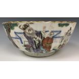 A set of three Chinese bowls, of lobed circular form, decorated figures in famille rose enamel