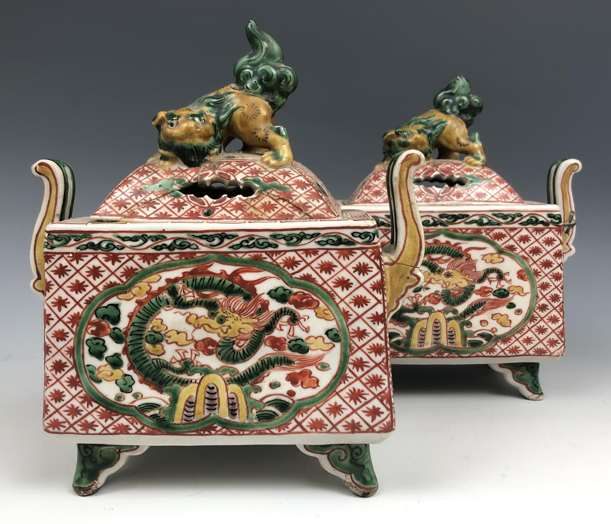 A pair of Chinese two handled censers and covers, decorated dragons, 17 cm high (2) some damage