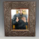 A Chinese wall mirror, with a carved wooden frame, decorated dragons, 49 x 39 cm