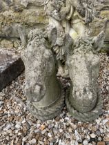 A pair of composite stone horses heads, 50 cm high
