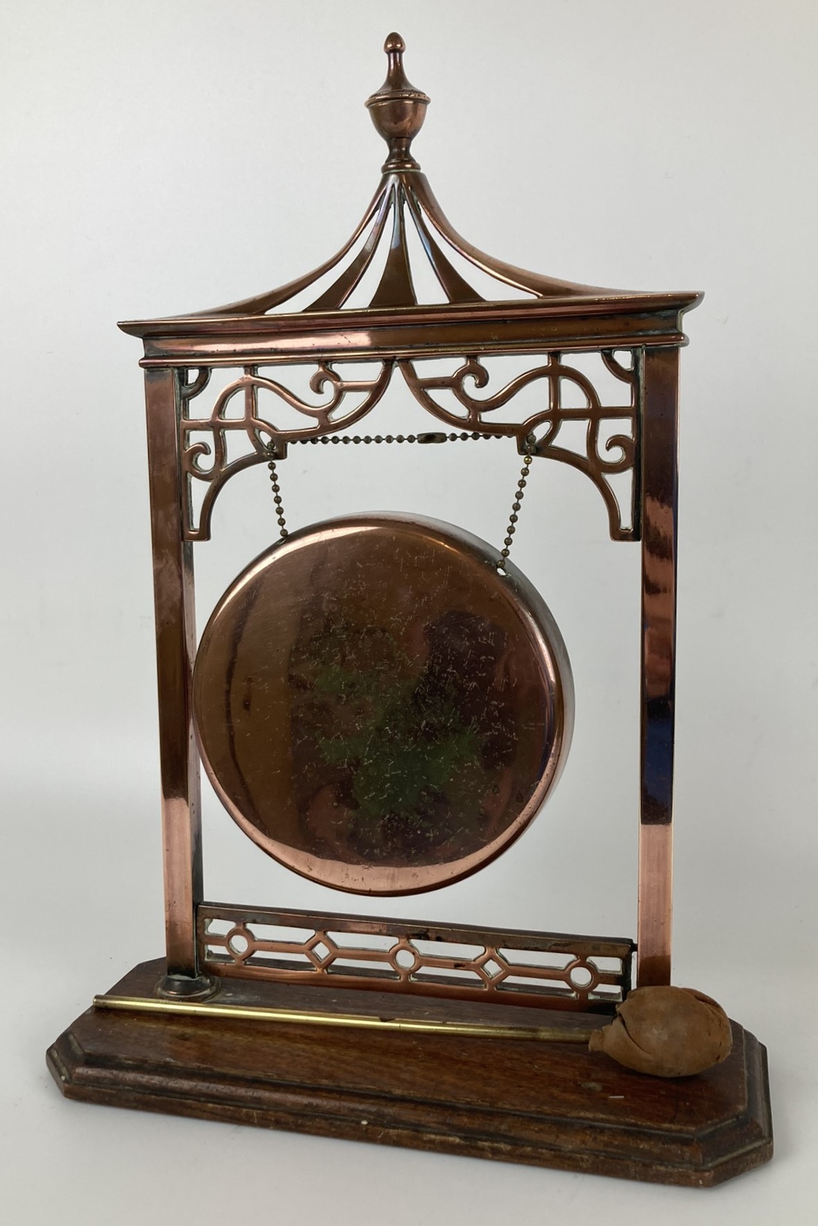 A copper table gong in the Chinese manner, on an oak base, 40 cm high