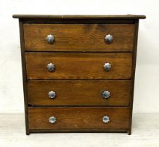 A stained pine table top chest, having four drawers, 30 cm wide