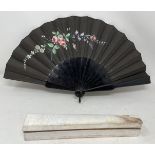 An ebonised fan, the silk painted flowers, 25 cm, boxed, and five other fans (6)