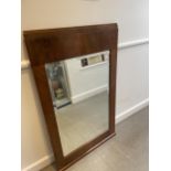 An Art Deco wall mirror, in a walnut frame, 123 x 75 cm