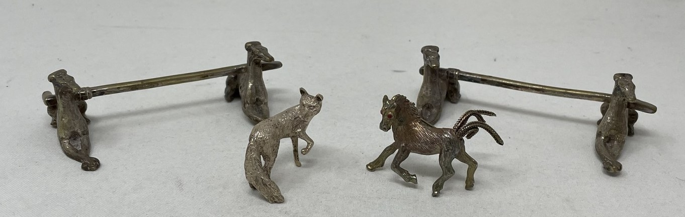 A pair of novelty silver plated knife rests, in the form of greyhounds, a brooch in the form of a