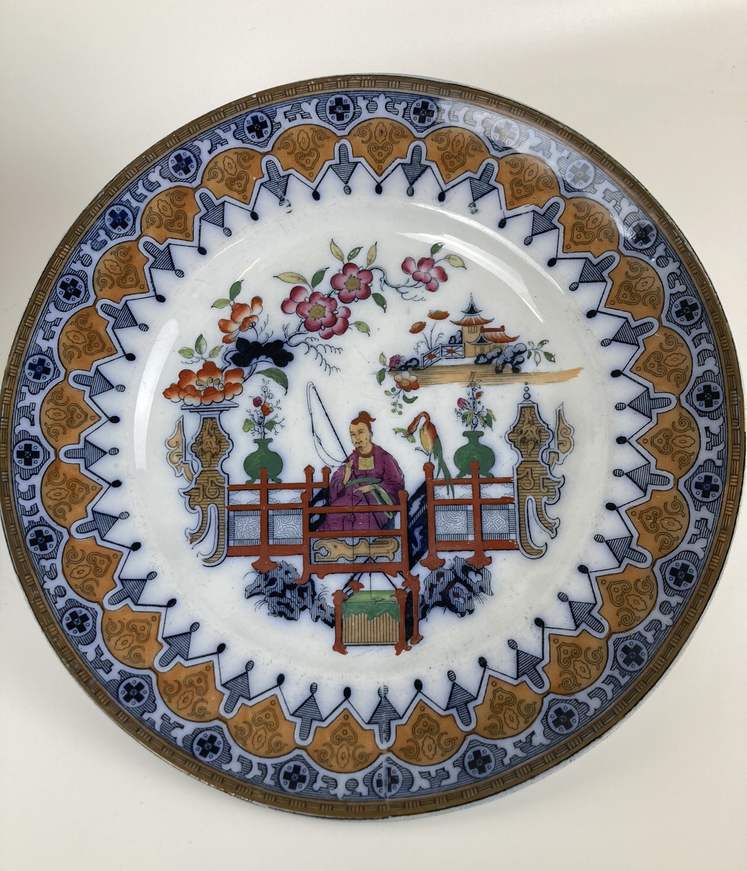 A Dutch porcelain group of an Eastern man pushing a lady in a cart, 20 cm high, and a plate (2) - Image 3 of 3