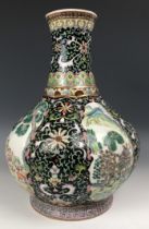 A Chinese famille noire vase, decorated figures, 30 cm high
