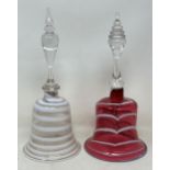 A cranberry, opaque and clear glass bell, 28 cm, and another glass bell, lacking ringers