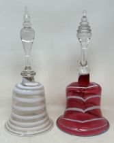 A cranberry, opaque and clear glass bell, 28 cm, and another glass bell, lacking ringers