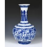 A Chinese blue and white bottle vase, decorated flowers in underglaze blue, bears a Qianlong mark,