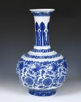 A Chinese blue and white bottle vase, decorated flowers in underglaze blue, bears a Qianlong mark,