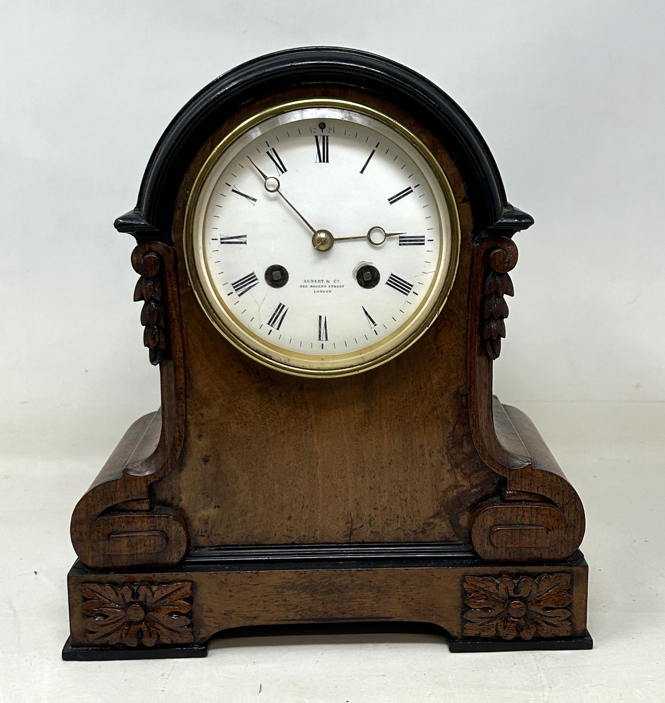 A mantel clock, by Aubert & Co, with an eight day movement, in a walnut case, 25 cm high