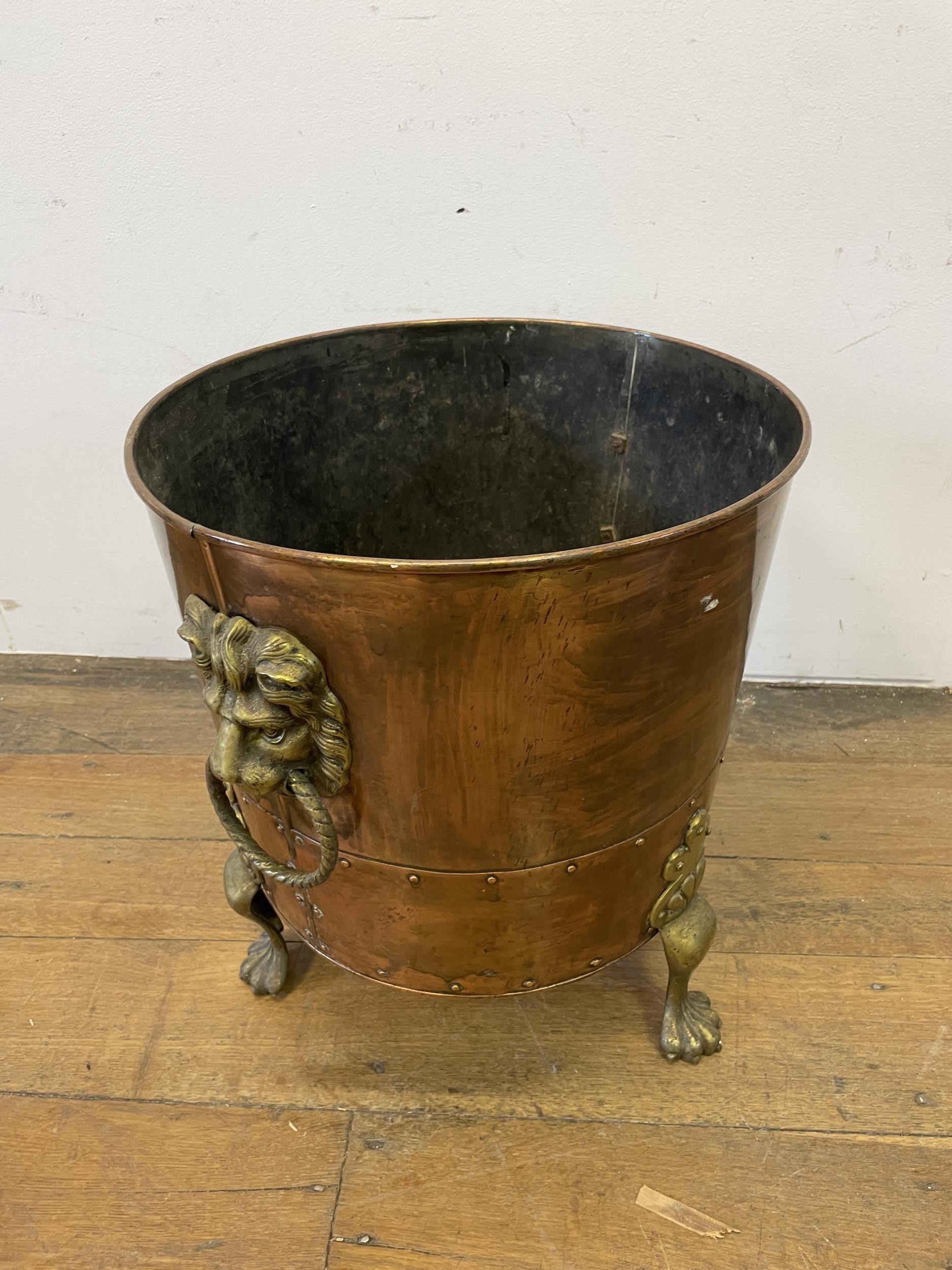 A copper and brass coal bucket, with lions head handles, 45 cm diameter, an oak table and a wine - Image 3 of 5