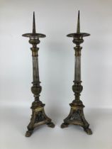 A pair of brass pricket candlesticks, 62 cm high