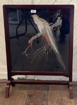 A silk embroidered panel, decorated exotic birds, inset in a firescreen with a mahogany frame, 72