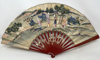 A Chinese carved fan, the paper decorated a landscape, 29 cm, a lacquered fan box, and a lacquered