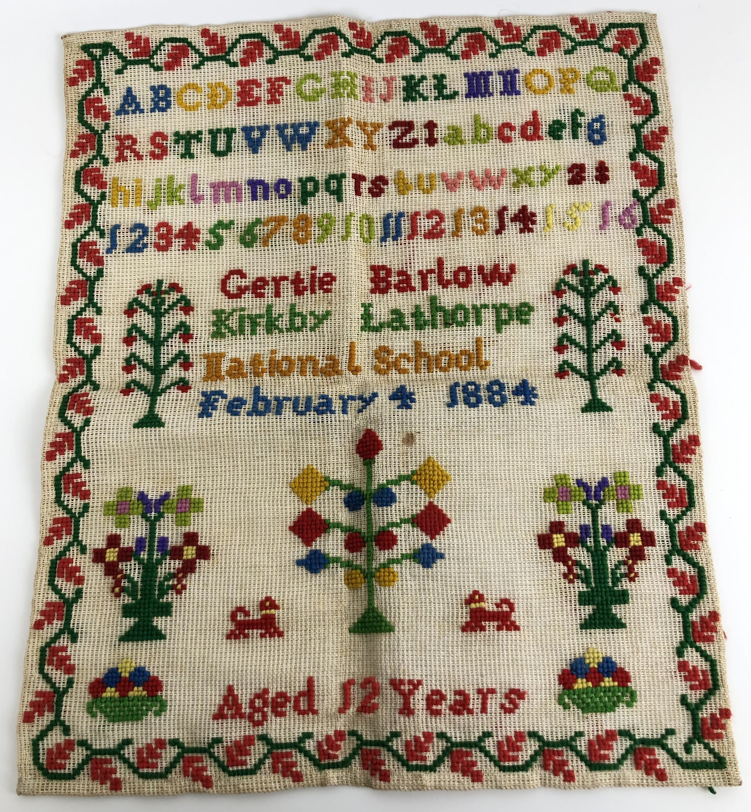 A Victorian sampler, signed Gertie Barlow of Kirkby Landthorpe National School, aged 12 years old,