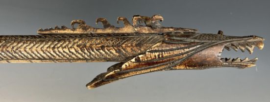 A carved bone blow pipe, in the form of a dragon, probably from Borneo, 82 cm