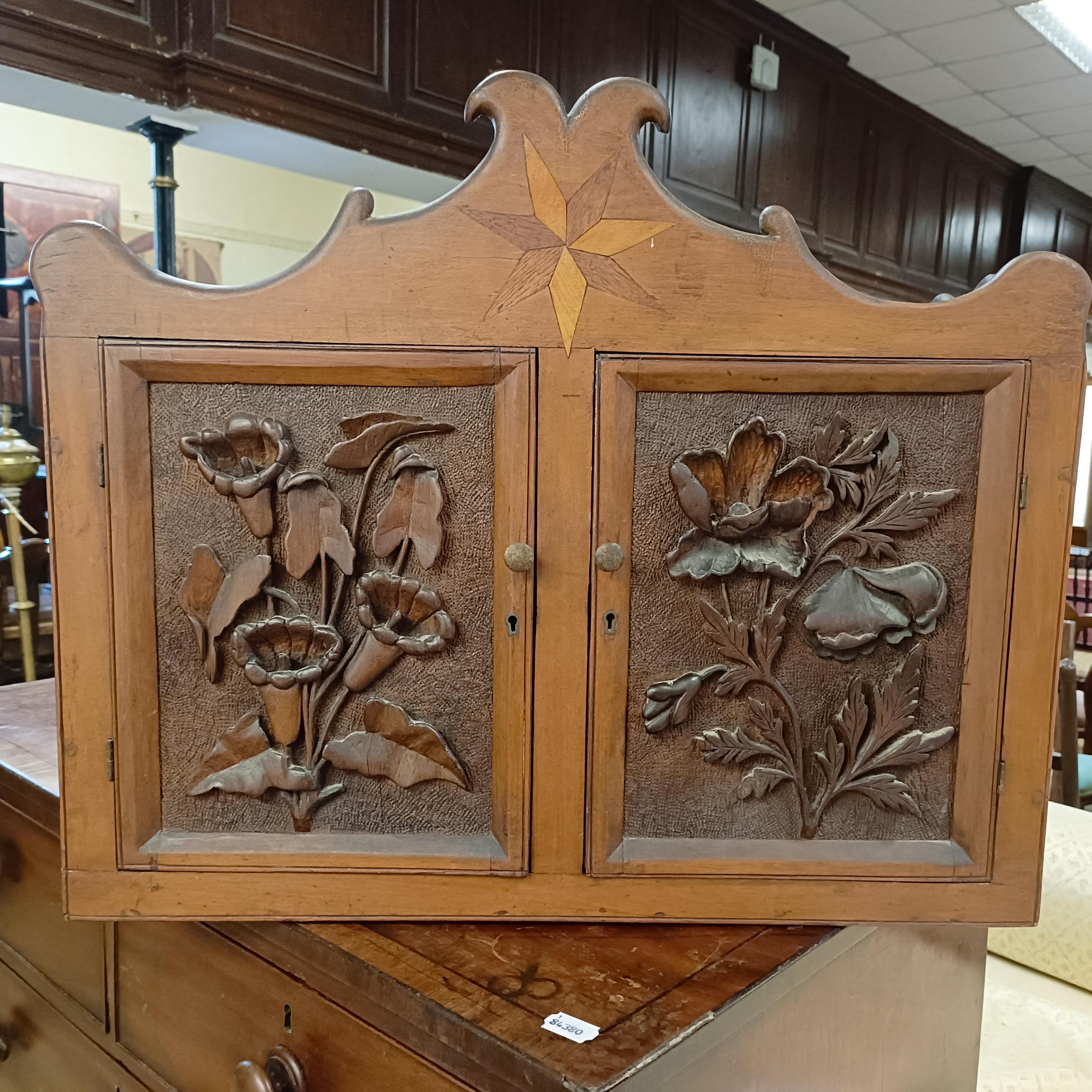 A walnut cupboard, decorated with carved flowers, 54 x 64 cm