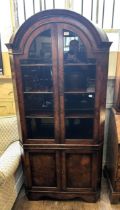 A walnut dome top corner cabinet, with two glazed doors above two cupboard doors, 90 cm wide