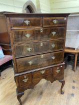 A walnut tallboy, the top having two short and three long drawers, the base with three drawers, on