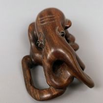 A carved wooden netsuke, in the form of an octopus, 5 cm wide and a carved wooden netsuke, in the