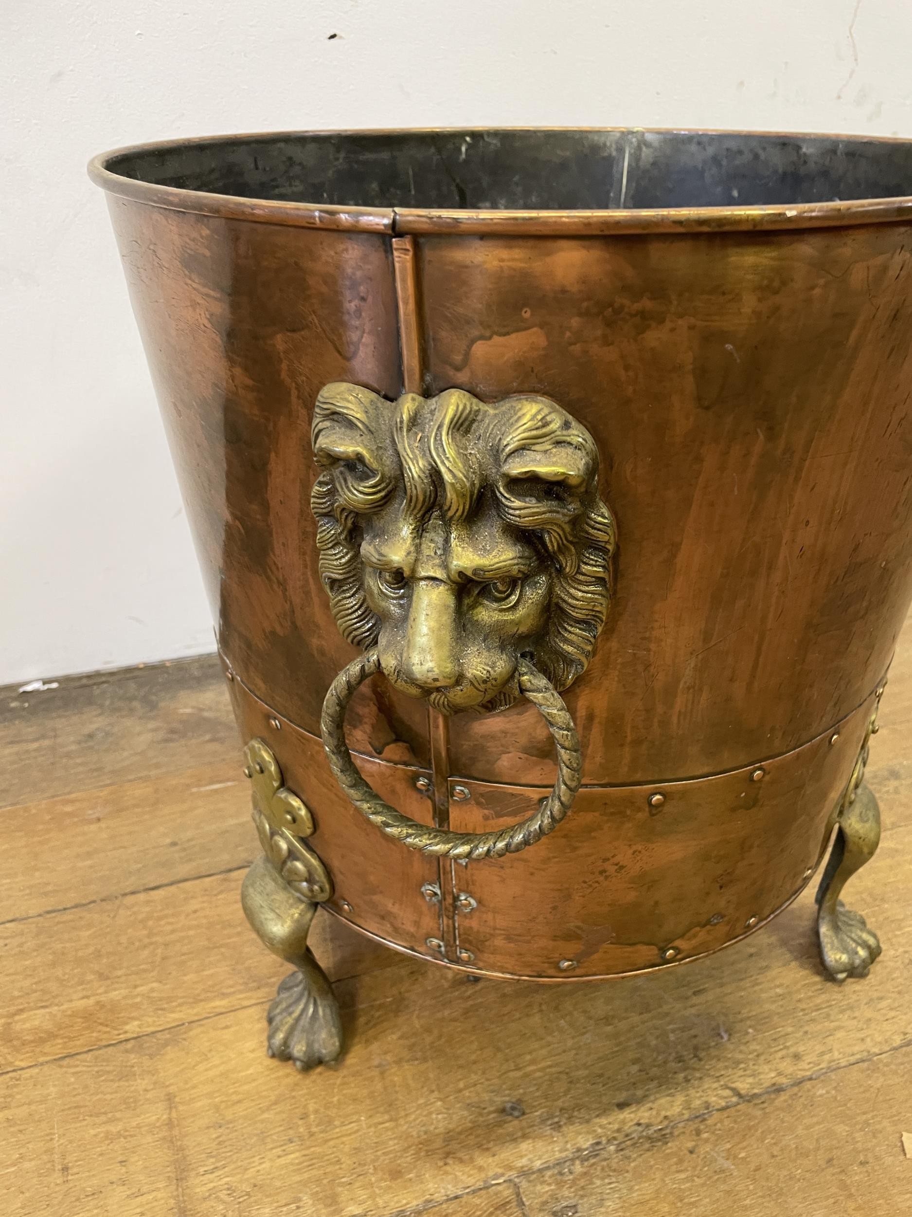 A copper and brass coal bucket, with lions head handles, 45 cm diameter, an oak table and a wine - Image 4 of 5