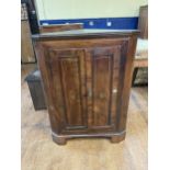 A mahogany corner cabinet, 82 cm wide, a painted corner cabinet, 69 cm wide, and a bookcase, 112
