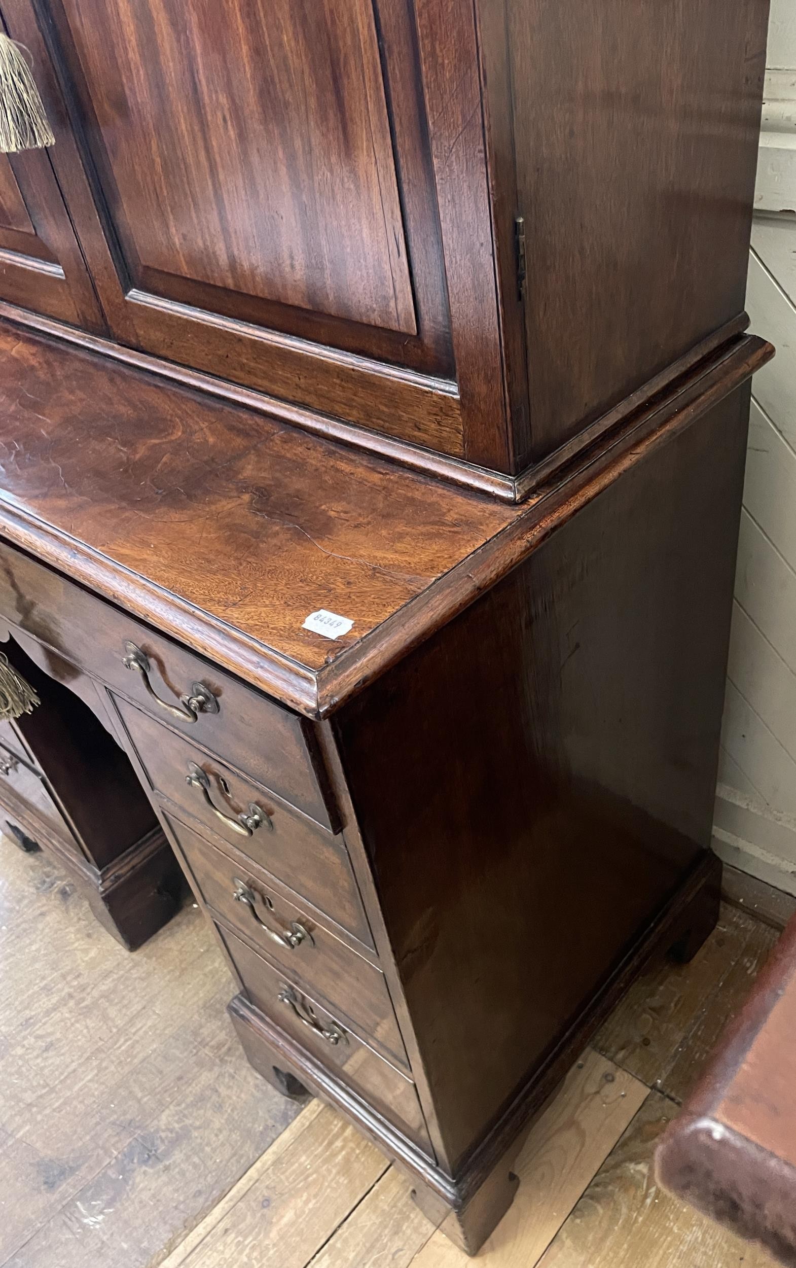 A 19th century mahogany kneehole desk, with a bookcase top having a pair of panel doors, opening - Image 6 of 9