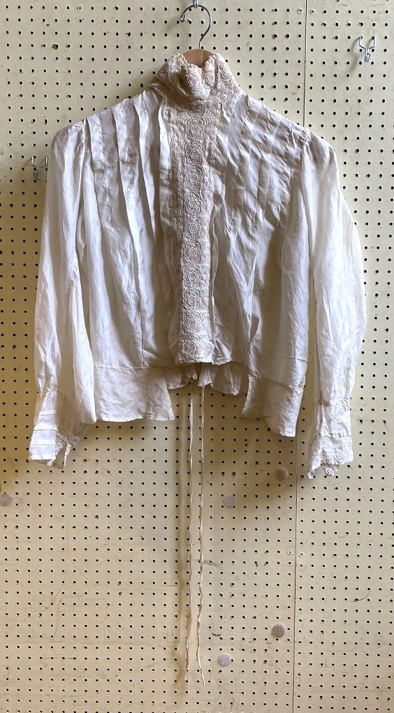 A late 19th century/early 20th century blouse, with a lace collar and trim