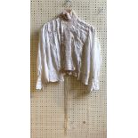 A late 19th century/early 20th century blouse, with a lace collar and trim