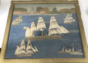 A Victorian sailor woolwork panel, decorated steam and other ships, with a lighthouse in the