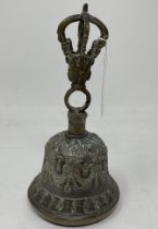 An Indo-Chinese style hand bell, 17.5 cm high, with a clapper