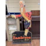 A vintage shop standee reading YOUR ZAMBRENE MADAM WEATHER COATS DISTINGUISHED SINCE 1858, extensive