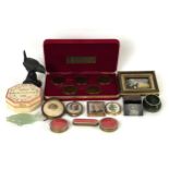 A gilt metal and enamel box, a set of coins and other items