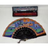 A lacquered fan, decorated figures, paper painted interior scene, 11 cm, boxed, and two other