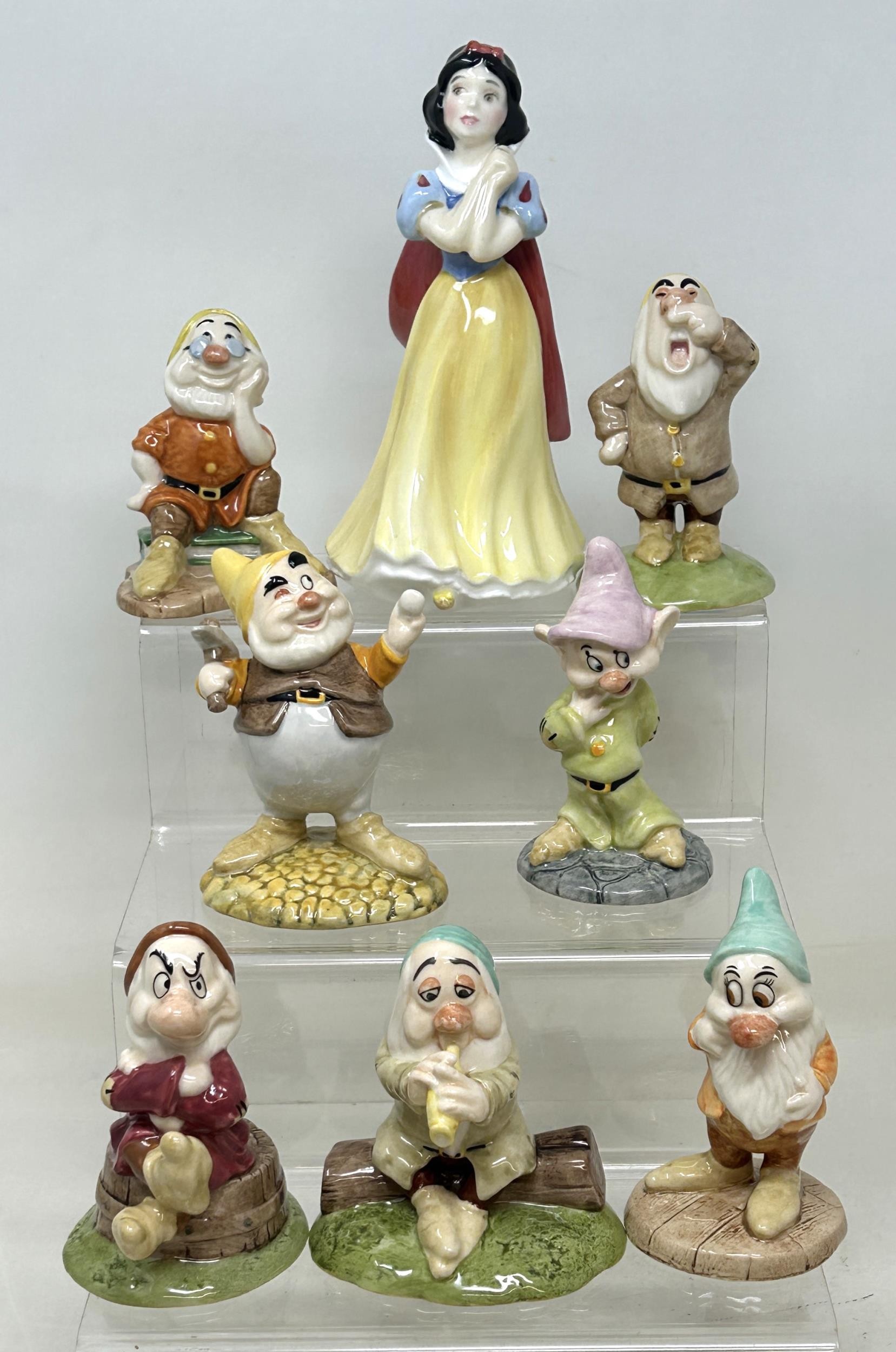 A Royal Doulton set of Snow White and the Seven Dwarfs, No 1135, boxed with certificate, a Bunnykins