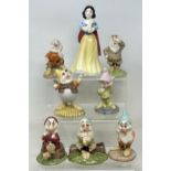 A Royal Doulton set of Snow White and the Seven Dwarfs, No 1135, boxed with certificate, a Bunnykins