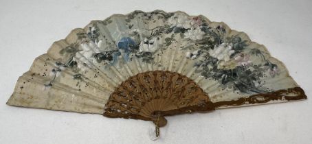 A carved giltwood fan, with pierced decoration, silk decorated butterflies, 10 cm, and two other