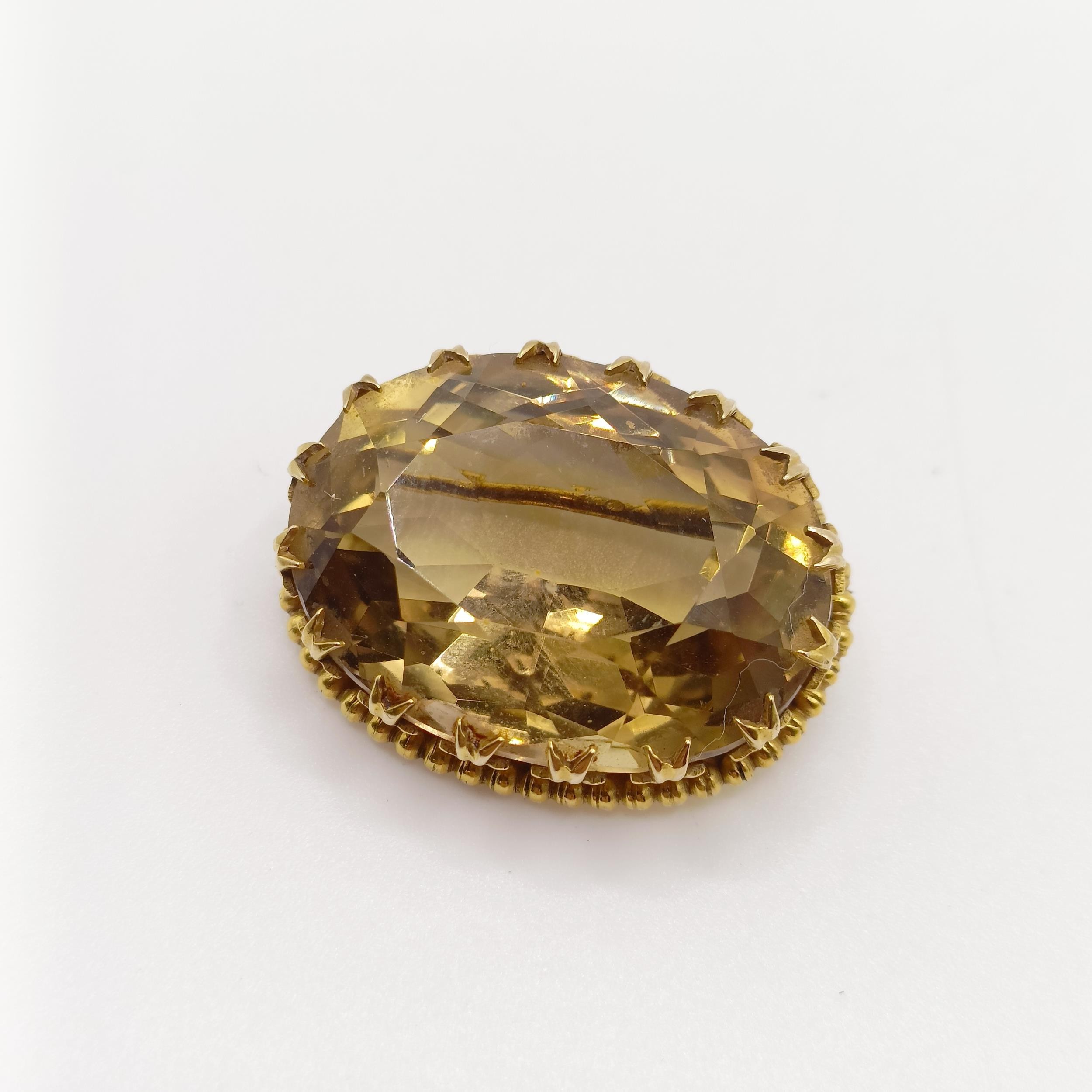 A citrine and yellow coloured metal brooch