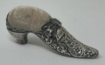 A novelty silver coloured metal pin cushion, in the form of a shoe