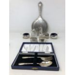 A pair of silver salts, a pepper pot, two napkin rings, a fork and spoon 6.6 ozt, a silver backed