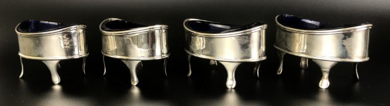 A set of four George III silver salts, of navette form, London 1802, with blue glass liners (4)