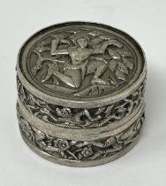 An Indian silver coloured metal pill box, decorated a figure, 19.2 g