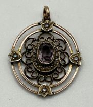 An early 20th century yellow metal, seed pearl and amethyst pendant